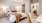 a bedroom with a bed and a chair