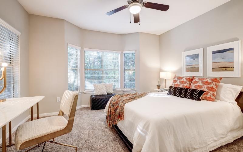 a bedroom with a bed and a chair