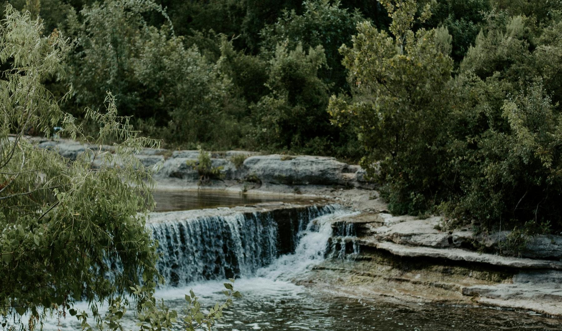 Find your perfect fit at Canyon Springs at Bull Creek a small pond surrounded by trees